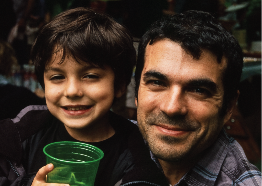 Jose Hernando and his son holding a green cup